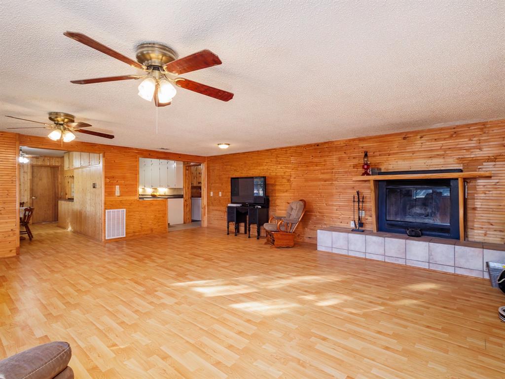 3301 County Road 339 Early, TX 76802 - Photo 2 of 39 a view of a livingroom with a fireplace and a ceiling fan