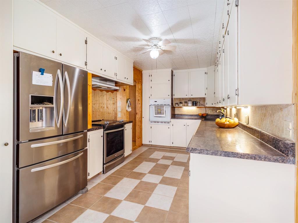 3301 County Road 339 Early, TX 76802 - Photo 25 of 39 a kitchen with granite countertop stainless steel appliances and a refrigerator