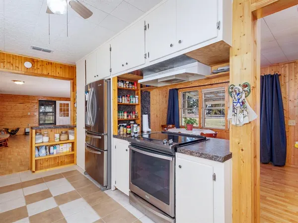 a kitchen with stainless steel appliances granite countertop a refrigerator and a stove top oven