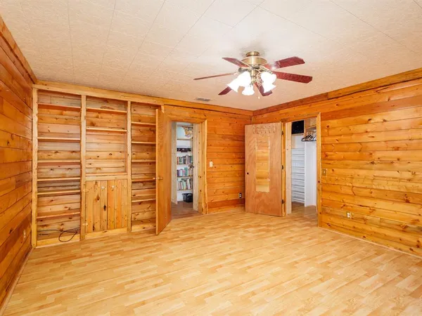 a view of an empty room with a ceiling fan