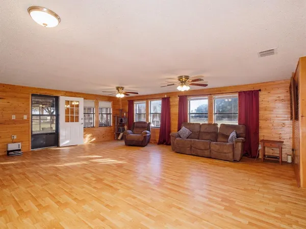 a living room with furniture and large windows