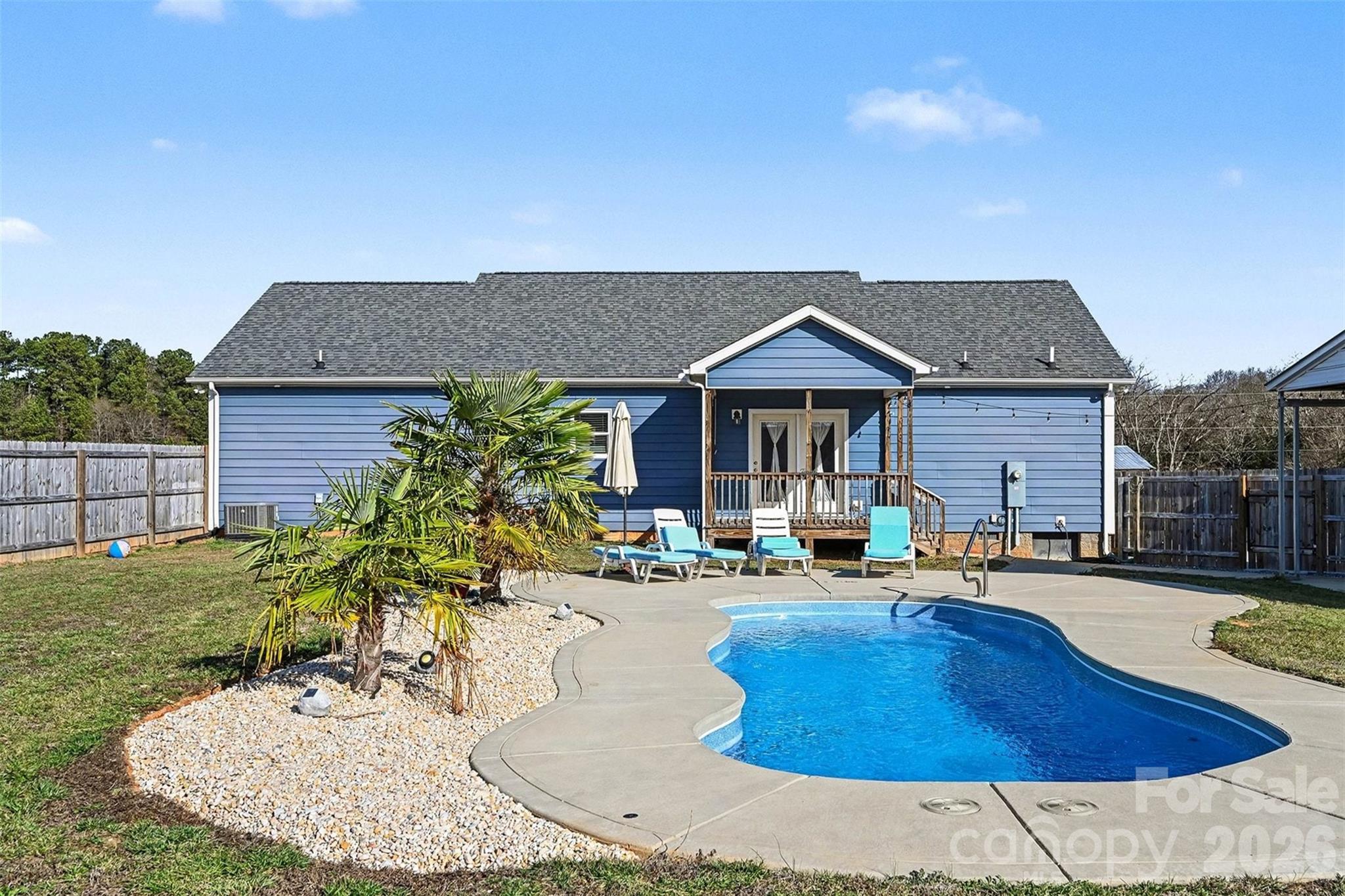 a swimming pool with outdoor seating yard and barbeque oven