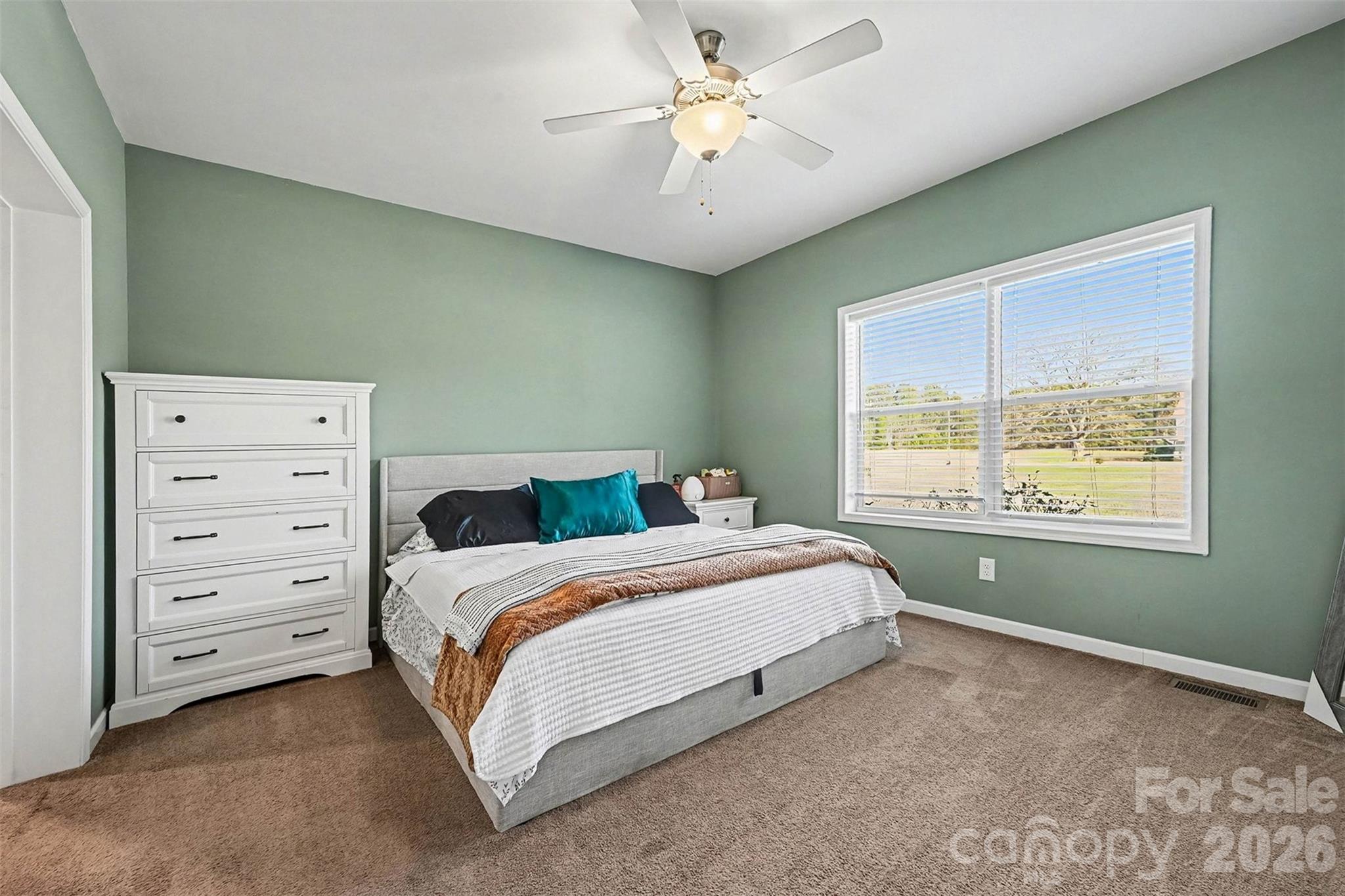 2268 Westbrook Road Edgemoor, SC 29712 - Photo 14 of 37 a spacious bedroom with a bed and a chandelier
