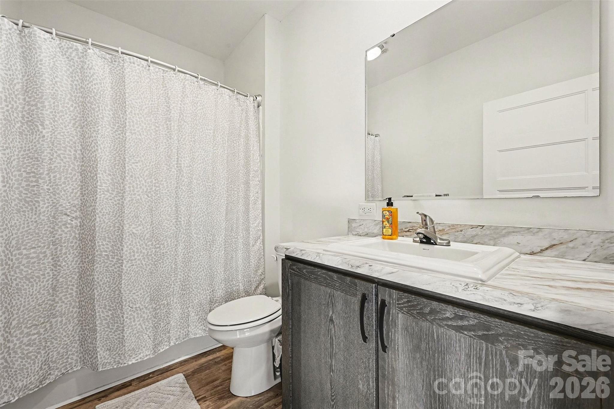 2268 Westbrook Road Edgemoor, SC 29712 - Photo 19 of 37 a bathroom with a granite countertop sink and a mirror