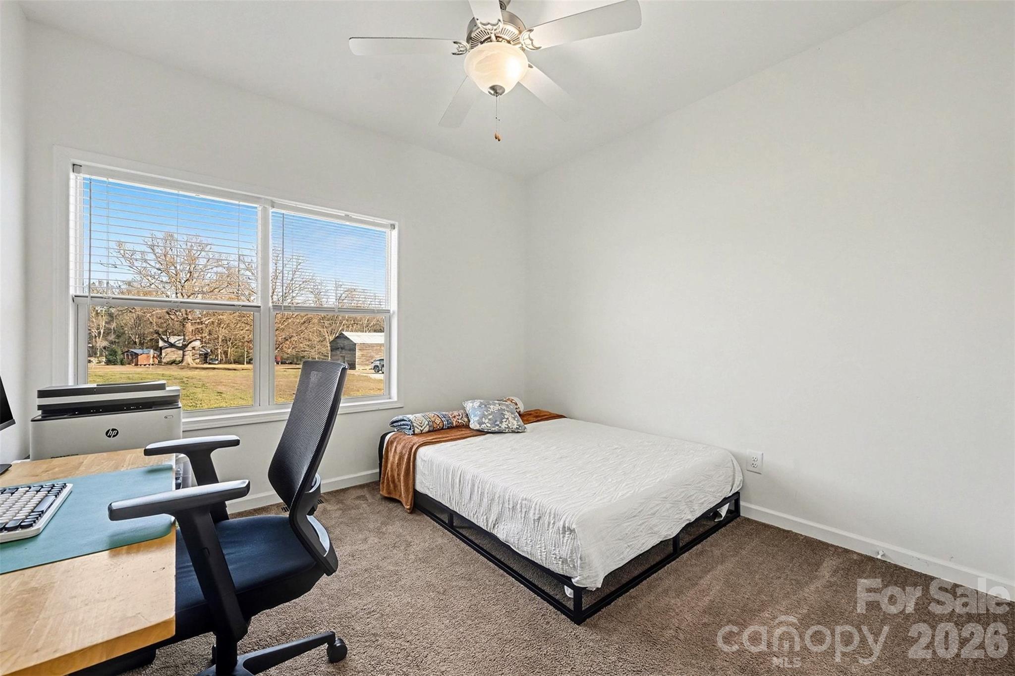 2268 Westbrook Road Edgemoor, SC 29712 - Photo 20 of 37 a bedroom with a bed a desk and chair