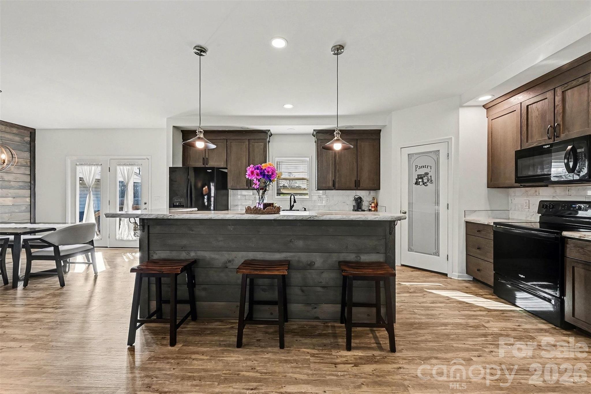 2268 Westbrook Road Edgemoor, SC 29712 - Photo 10 of 37 a kitchen with stainless steel appliances kitchen island granite countertop a table chairs sink and cabinets