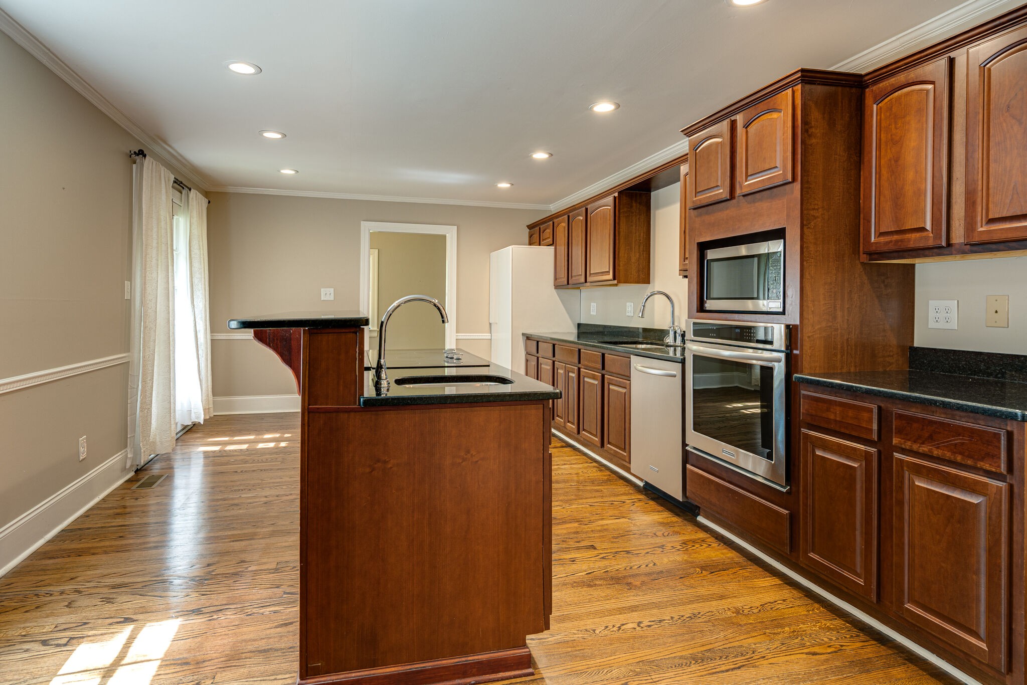 106 Winslow Road Franklin, TN 37064 - Photo 8 of 37 a kitchen with stainless steel appliances granite countertop a refrigerator a stove and a sink