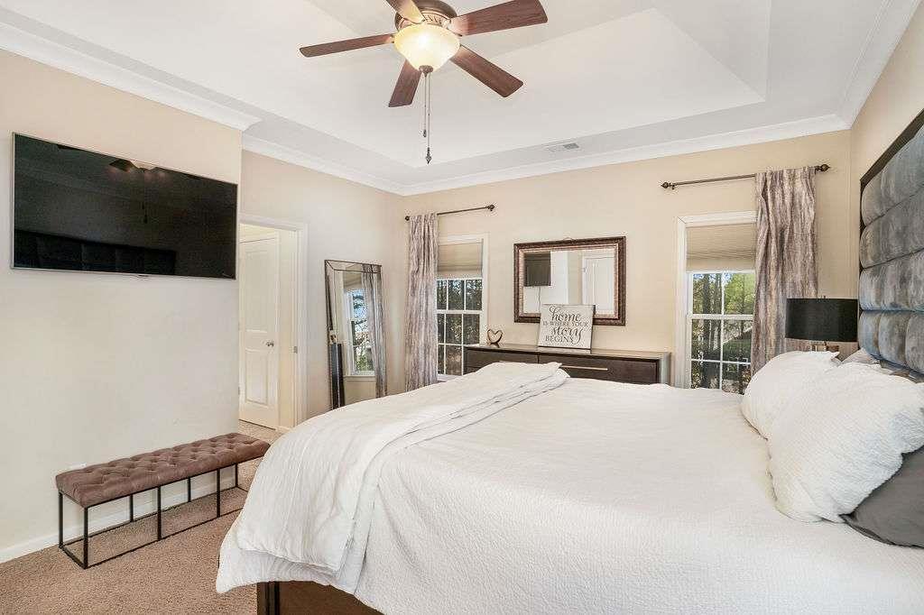 6463 Century Park Place Southeast Mableton, GA 30126 - Photo 21 of 42 a spacious bedroom with a bed and a flat screen tv