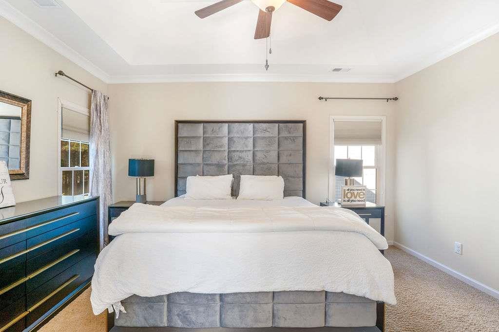 6463 Century Park Place Southeast Mableton, GA 30126 - Photo 24 of 42 a bedroom with a large bed and a chandelier