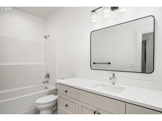 a bathroom with a sink a toilet and a bathtub