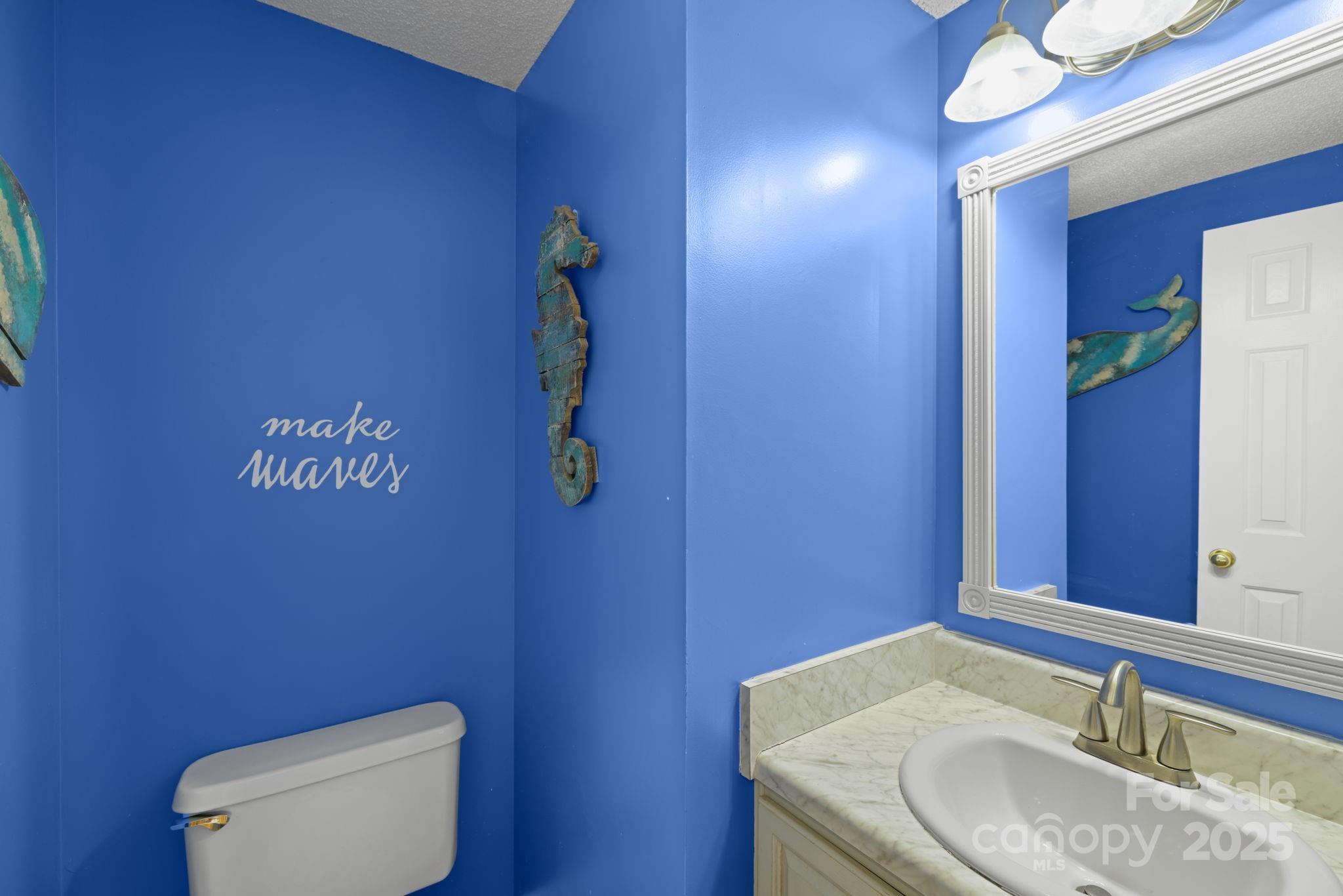 32 Wheat Ridge Road Sylva, NC 28779 - Photo 17 of 44 a bathroom with a granite countertop toilet and a sink