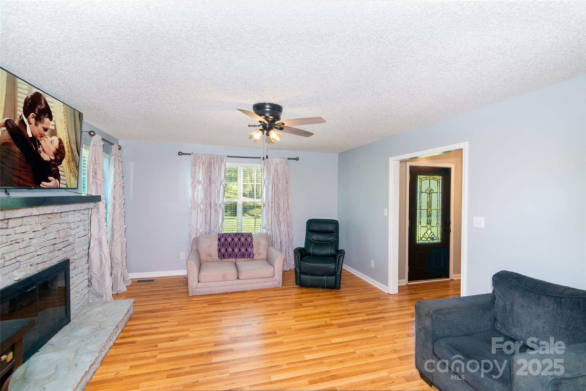 32 Wheat Ridge Road Sylva, NC 28779 - Photo 19 of 44 a living room with furniture and a fireplace