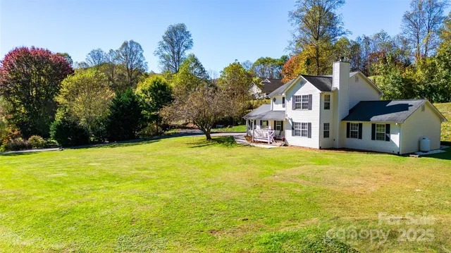 a front view of a house with a big yard