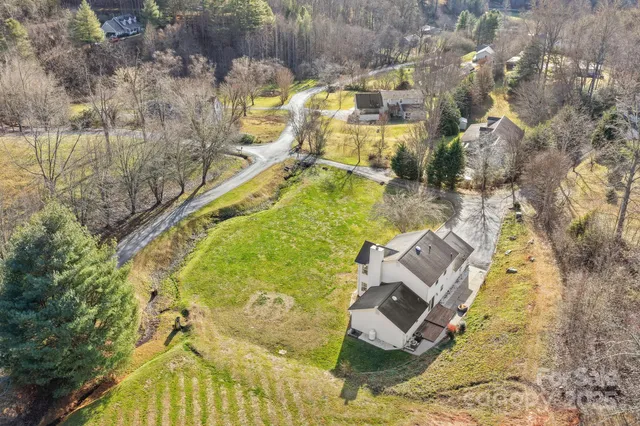 an aerial view of a house with a yard