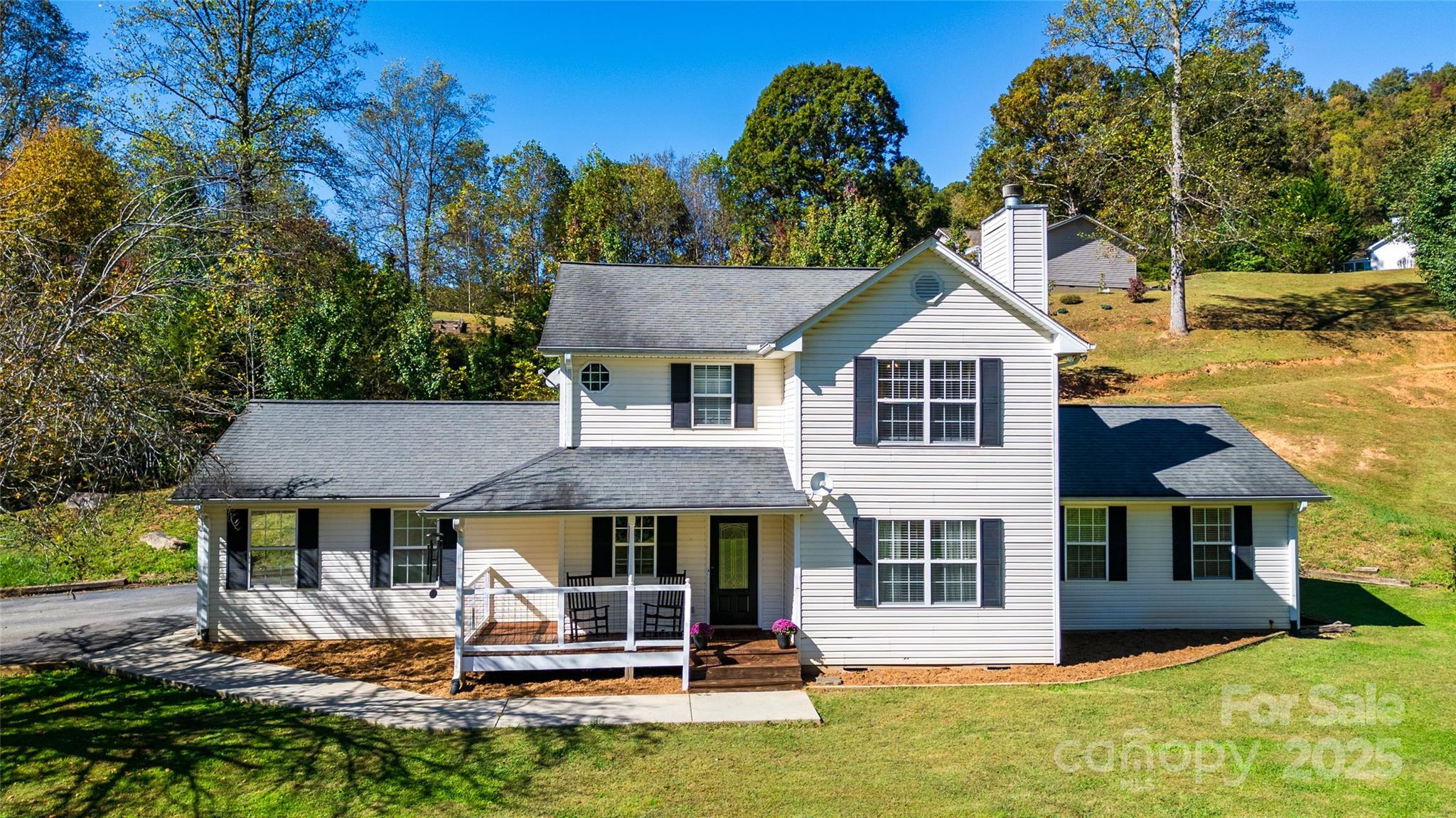 32 Wheat Ridge Road Sylva, NC 28779 - Photo 5 of 44 a front view of a house with a yard table and chairs