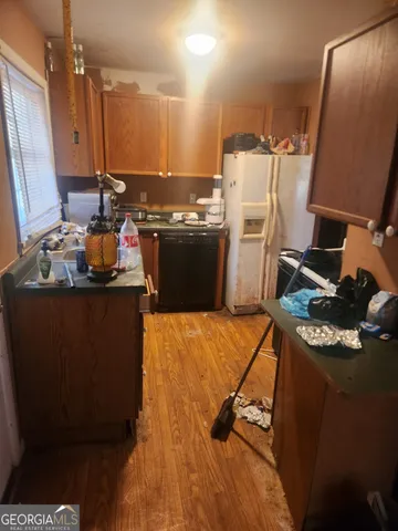 a kitchen with a sink appliances and cabinets