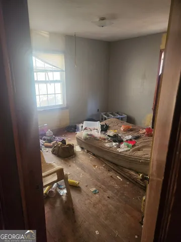 a bed sitting in a bedroom next to a window