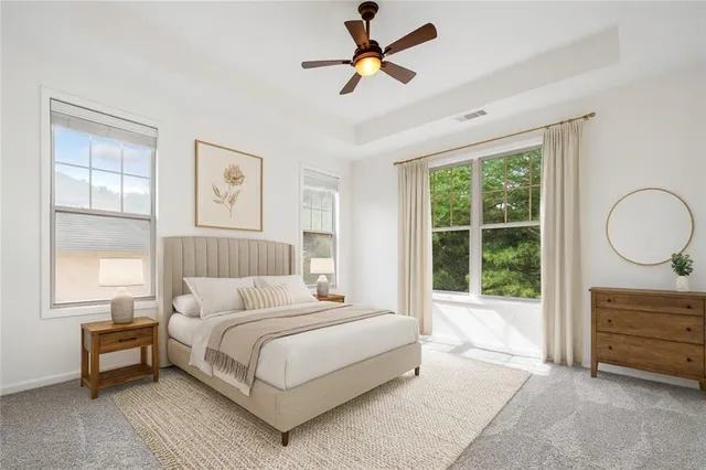 a bedroom with a bed a dresser and a large window