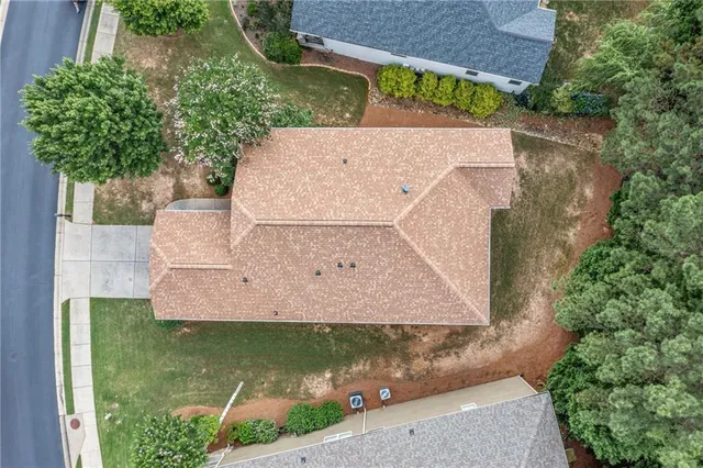 an aerial view of a house with a yard