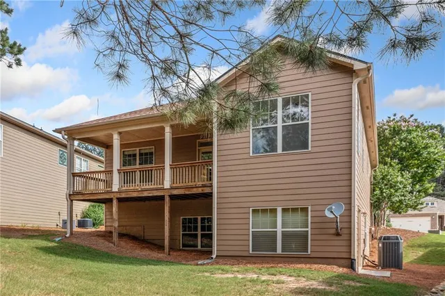 a view of a house with a large window and a yard