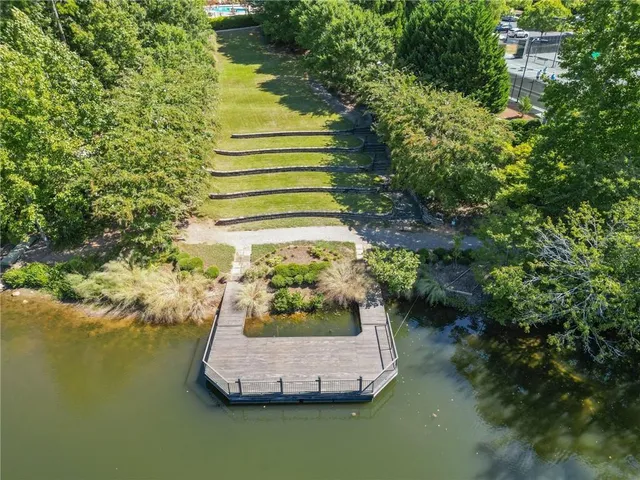 an aerial view of a house with a yard and lake view