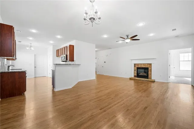 a view of empty room with wooden floor and fireplace