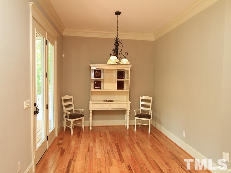 1305 Mason Road Durham, NC 27712 - Photo 12 of 25 a workspace with wooden floor and white walls