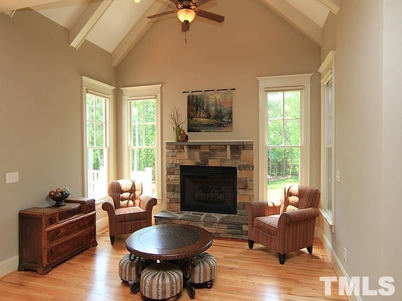 1305 Mason Road Durham, NC 27712 - Photo 13 of 25 a living room with furniture a fireplace and a large window