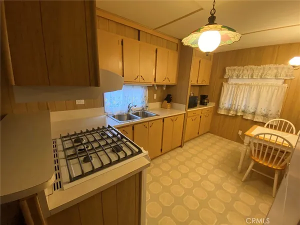 a kitchen with a sink and a stove top oven