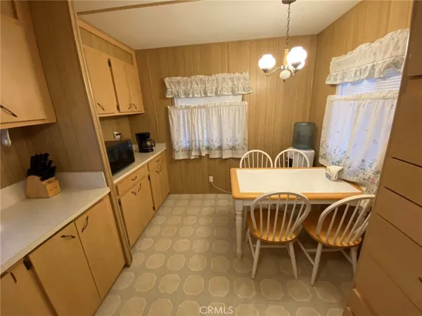 a dining room with furniture and chandelier