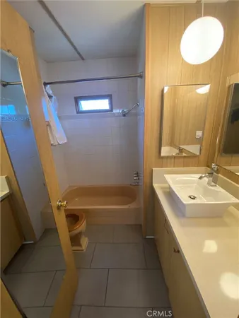 a bathroom with a sink a toilet and bathtub