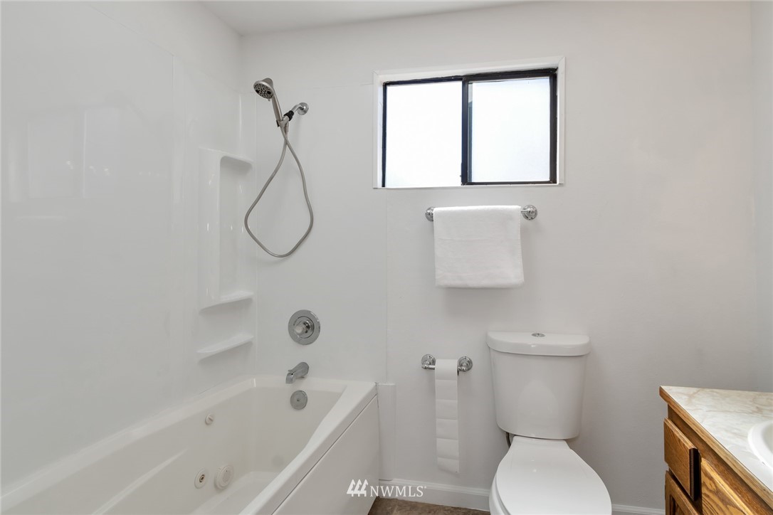 14635 Southeast 140th Place Renton, WA 98059 - Photo 22 of 33 a bathroom with a toilet and a bath tub
