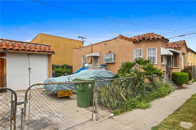 a view of a house with pool and sitting area