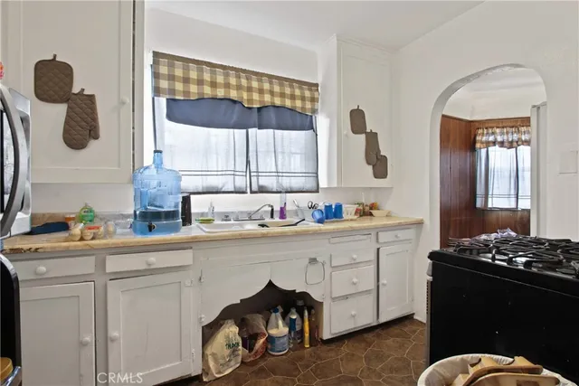 a kitchen with a sink and cabinets