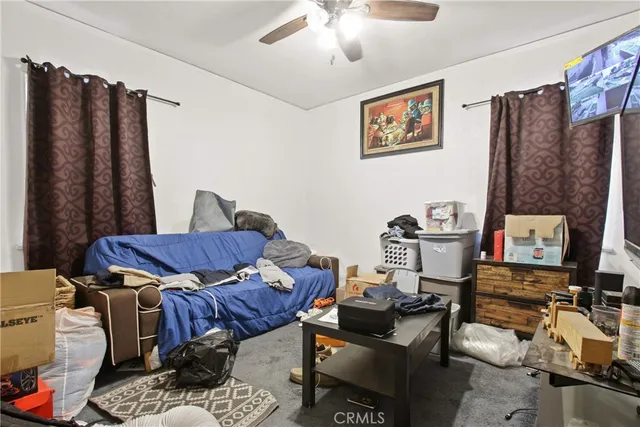 a living room with furniture and a piano