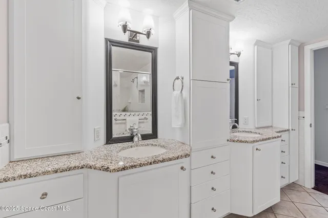 a front view of a house with a yard and potted plants