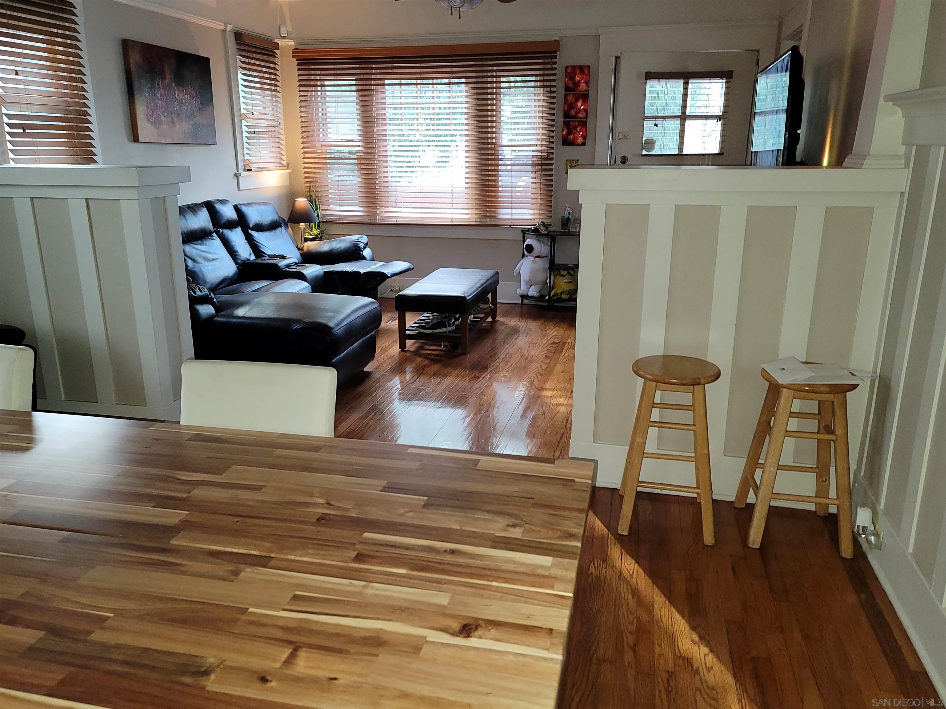 3975 8th Avenue San Diego, CA 92103 - Photo 3 of 4 a living room with furniture floor to ceiling window and wooden floor