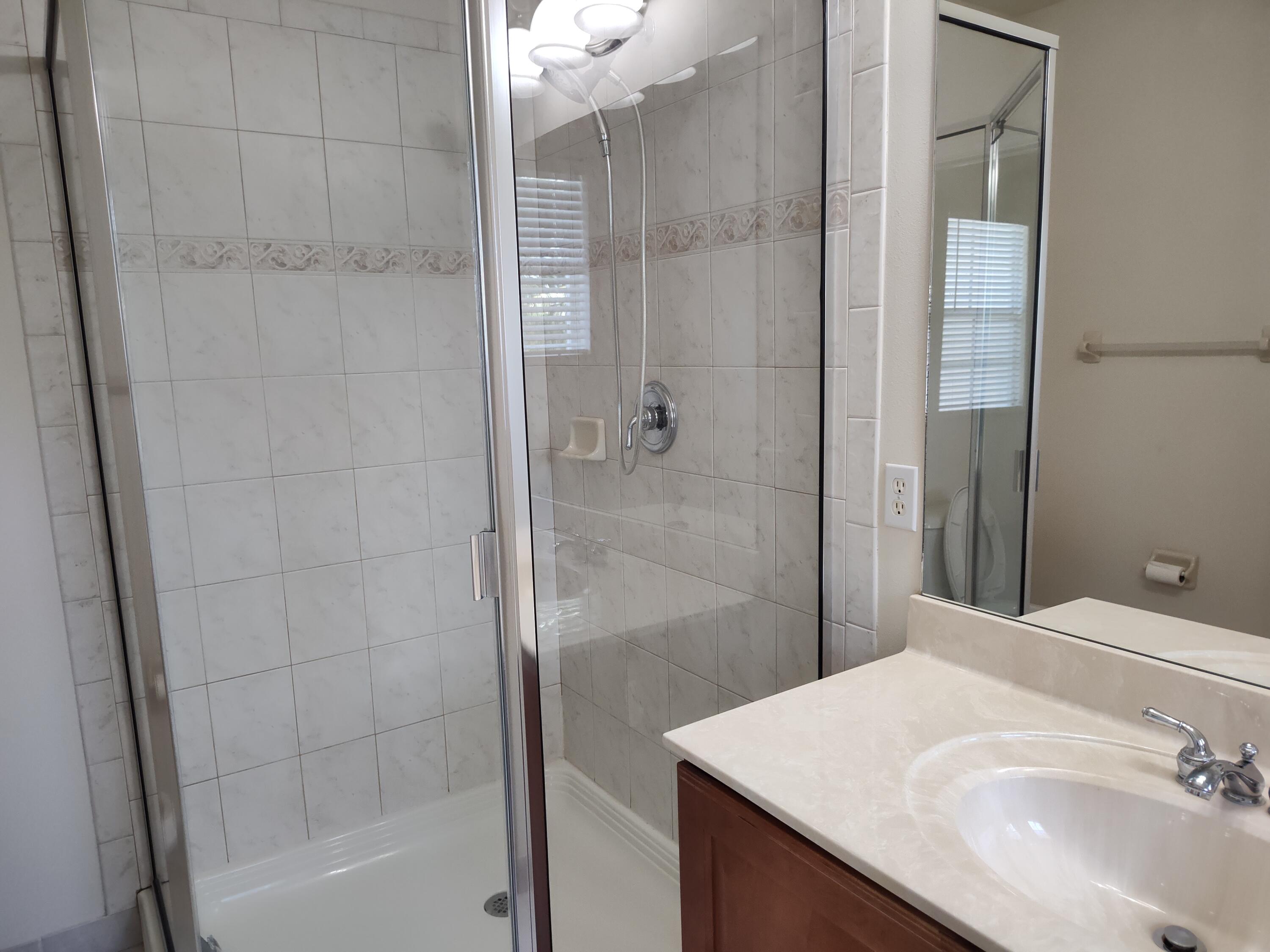 265 Indian Creek Parkway, Unit 102 Jupiter, FL 33458 - Photo 11 of 21 Primary Bedroom Shower