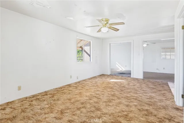 a view of a kitchen with an empty space and window