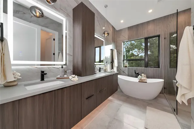 a bathroom with a sink vanity and mirror