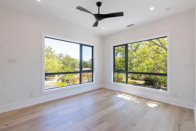 a bathroom with a granite countertop sink toilet and mirror