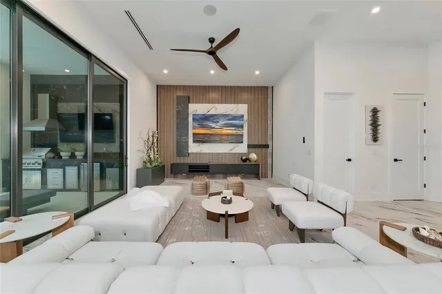 a living room with furniture a large window and a flat screen tv