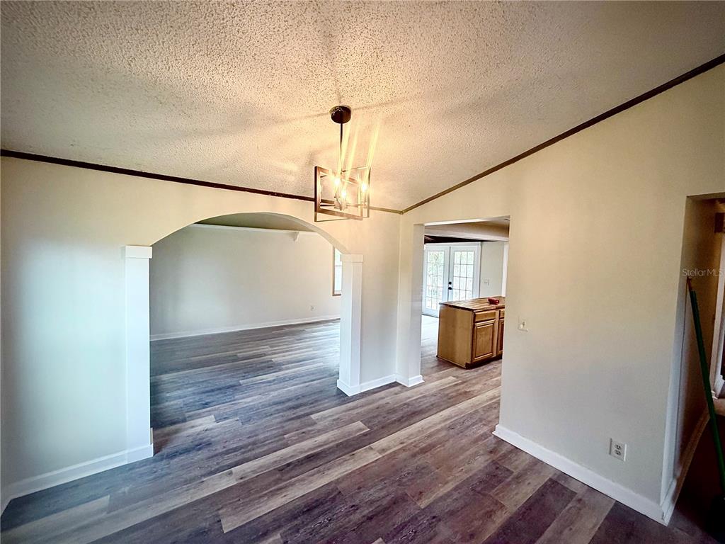 375 Pine Woods Road Ormond Beach, FL 32174 - Photo 6 of 16 a view of a room with wooden floor and stairs