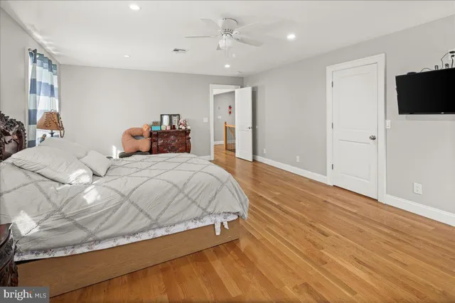 a bathroom with a granite countertop bathtub sink vanity mirror and toilet
