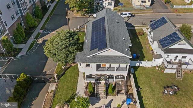 an aerial view of a house with garden space and swimming pool