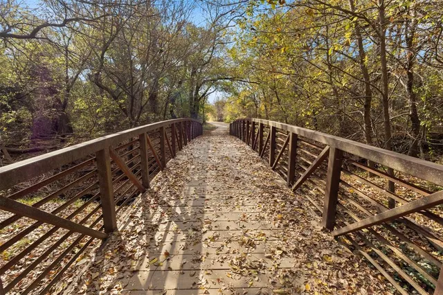 a view of balcony with wooden floor and fence