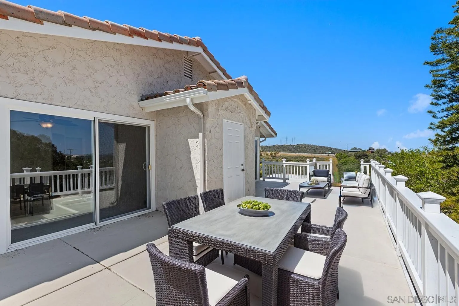 3049 Millar Ranch Road Spring Valley, CA 91978 - Photo 27 of 71 a view of a patio with table and chairs with wooden floor and fence
