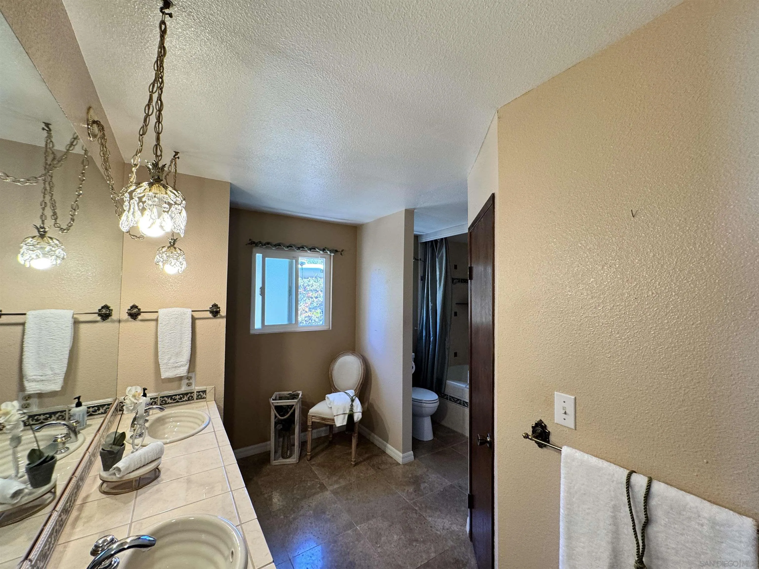 3049 Millar Ranch Road Spring Valley, CA 91978 - Photo 28 of 71 a living room with furniture a chandelier and a fireplace