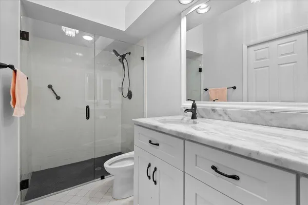 a bathroom with a granite countertop sink and a mirror