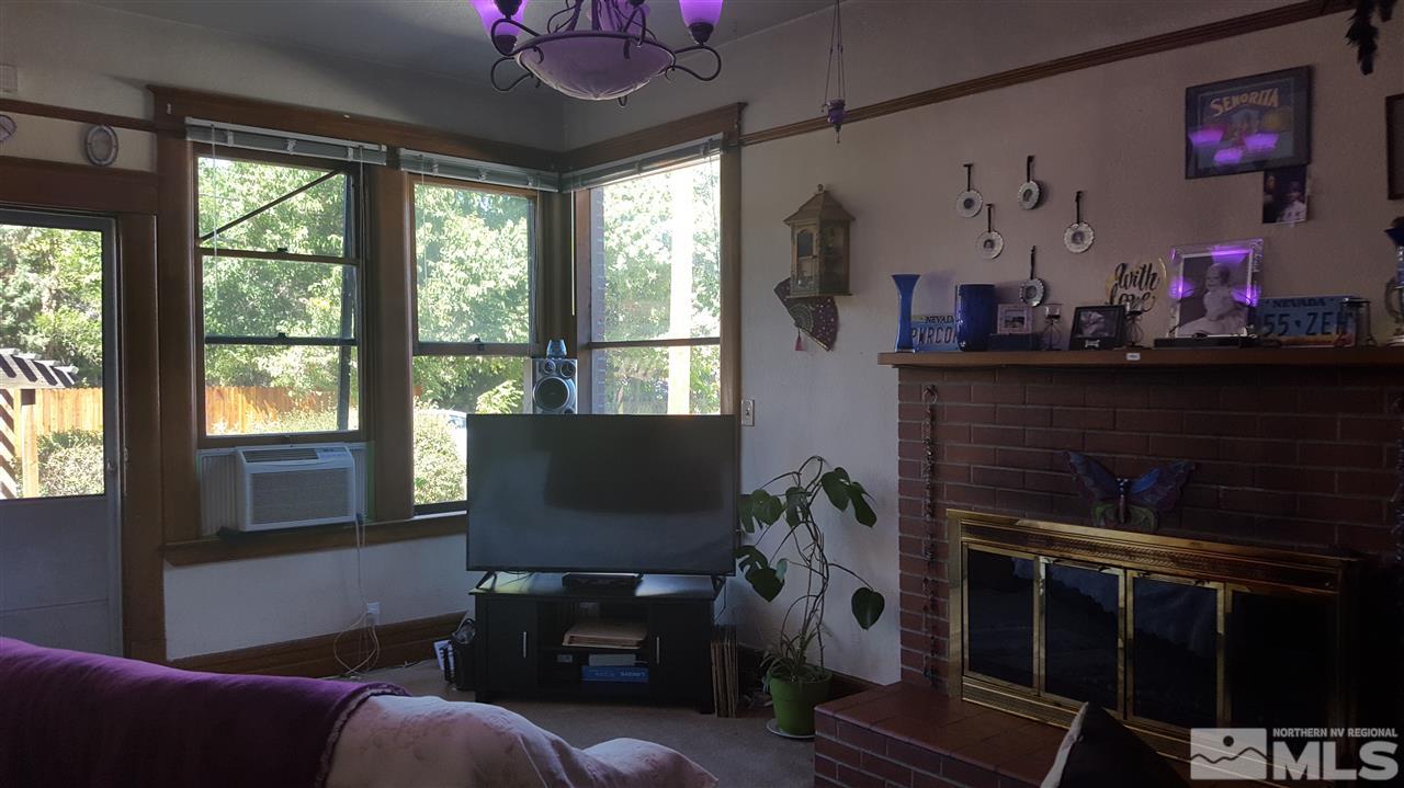 1120 Jones Street Reno, NV 89503 - Photo 4 of 25 a living room with furniture a flat screen tv and a fireplace